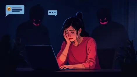 Young woman in dark room glowing screens online harassment fear